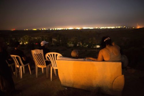 Jews laugh, eat, and drink as they view the bombing of Gaza from a nearby hill. Clearly, they have no fear of "Palestinian rockets."