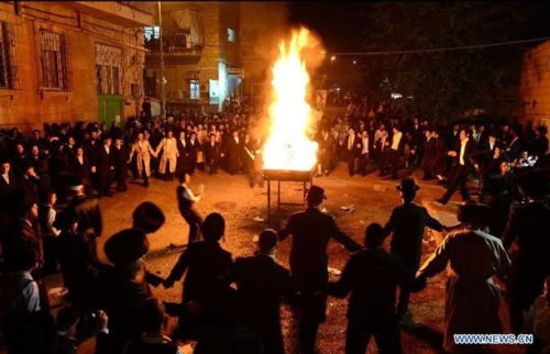 Jerusalem, April 27, 2013: Ultra-Orthodox Jews dance around a bonfire on Lag BaOmer, a Jewish holiday that has been reinterpreted in modern times as a commemoration of the Bar Kokhba revolt.