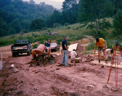 William Pierce, National Alliance members, and their families help lay the foundation for the main building on The Land in 1985