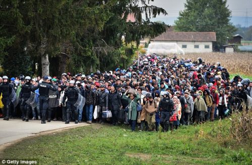 Exodus: Thousands of migrants (pictured, escorted by police) marched from Croatia into Slovenia as authorities intensified their efforts to cope with Europe's largest migration of people since the Second World War.