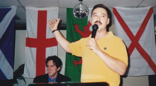 Mark Cotterill addressing an AF-BNP meeting in Arlington, Virginia in July 1999. Vincent Breeding, then election campaign manager for David Duke is seated to his left.