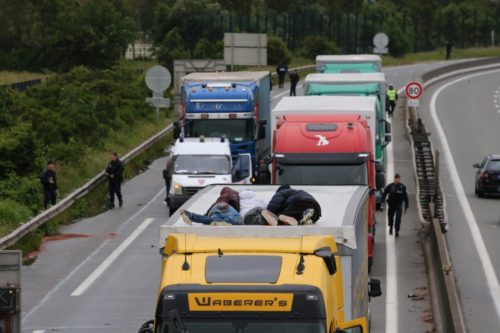 Three men lie on top of the HGV